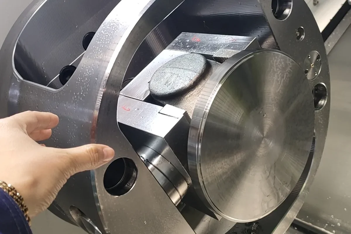 Handemo slant bed lathe being assembled in the workshop with a technician working on the machine
