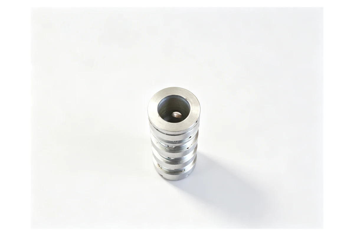 Stacked stainless machined discs and a valve body used in a filling machine product path