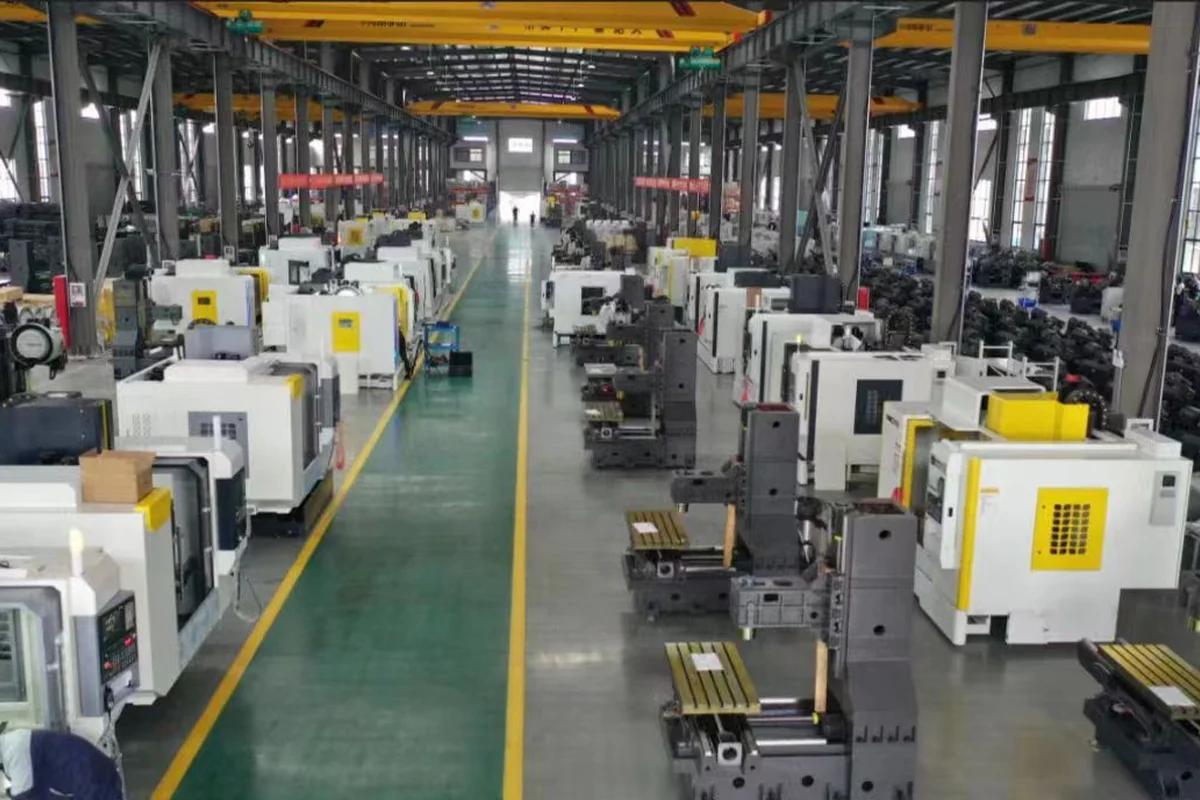 Handemo CNC workshop floor with machining centers arranged along a marked aisle